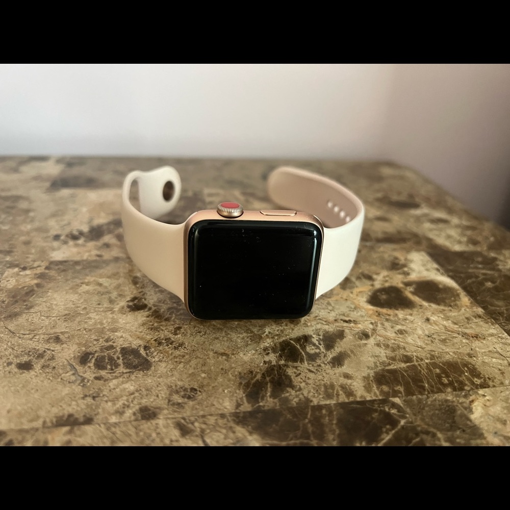 Apple Watch series 3 42mm rose gold with pink band and Tory Burch leather band.